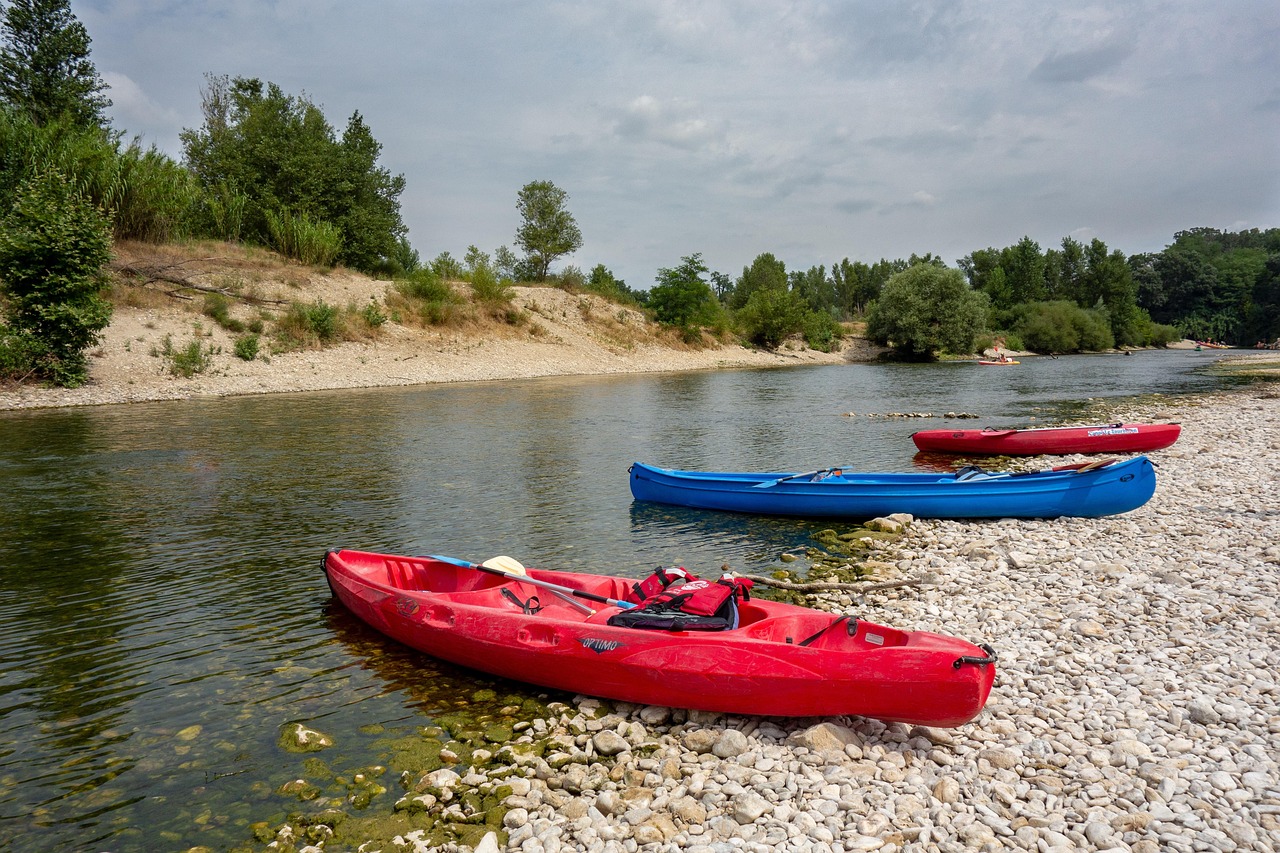 red and blue kayak on beach during daytime